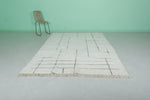 Minimalist Moroccan Rug - 6.4 x 9.7 ft | White with Abstract Line Pattern